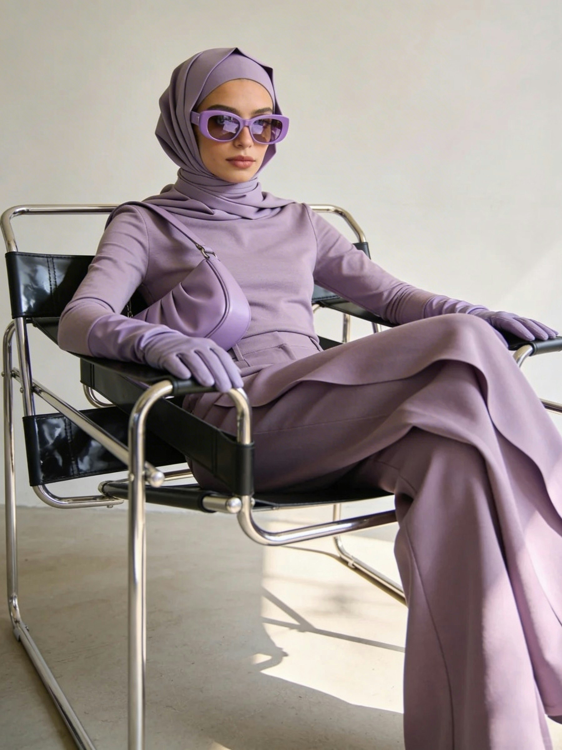 Model in the lavender drape set seated in a chrome chair